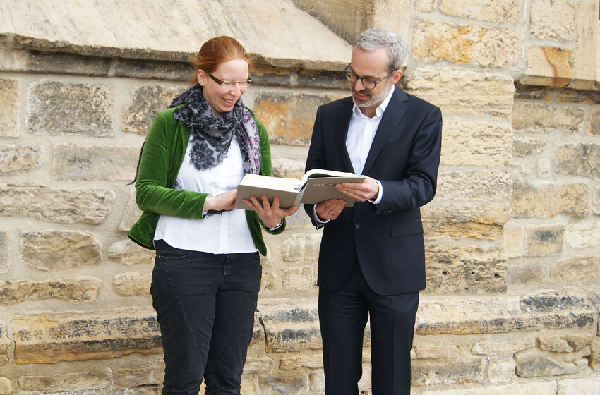 Riikka Hinkelmann und Mirko Peisert schauen in die Lutherbibel