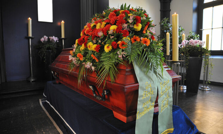 Bestattung & Vorsorge - Sarg mit Blumenschmuck